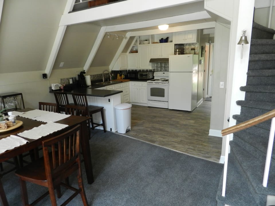 Kitchen,Dining,front entry hall,spiral stairs to loft bedroom
