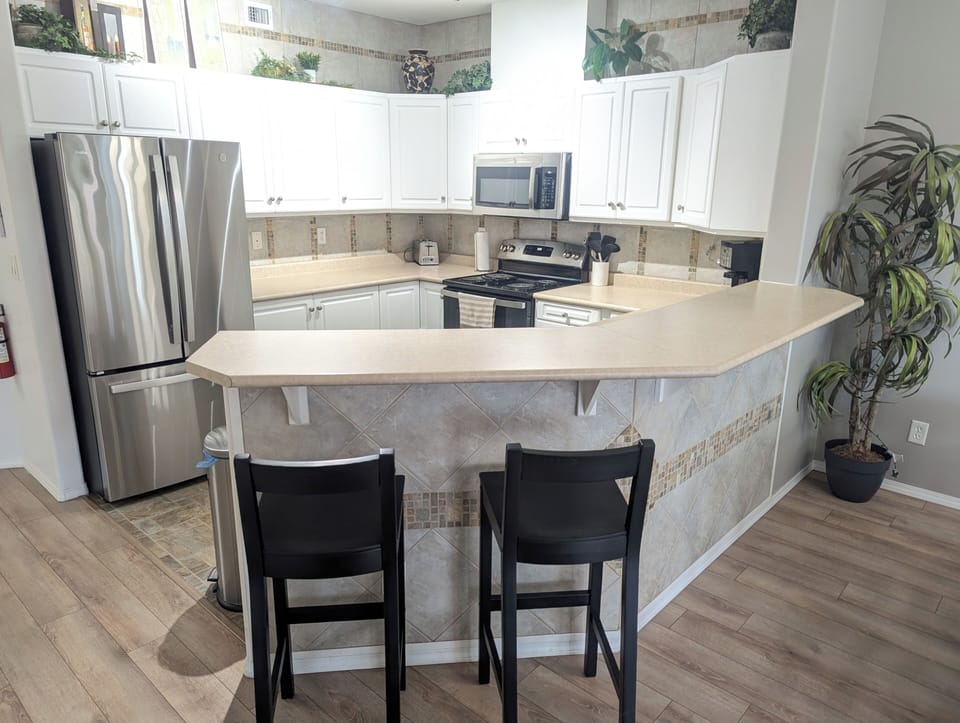 The kitchen has an island and bar stools that can seat two guests.