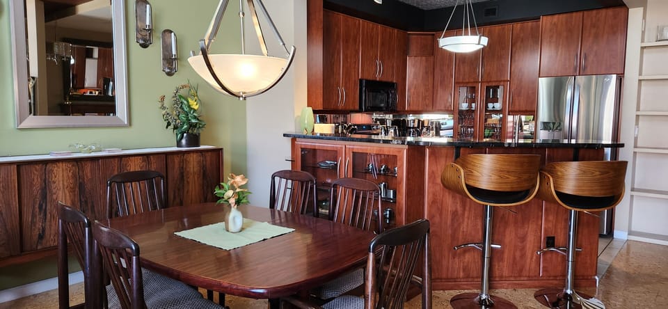 Dining Area features a six person stunning wood table and two extra bar stools.