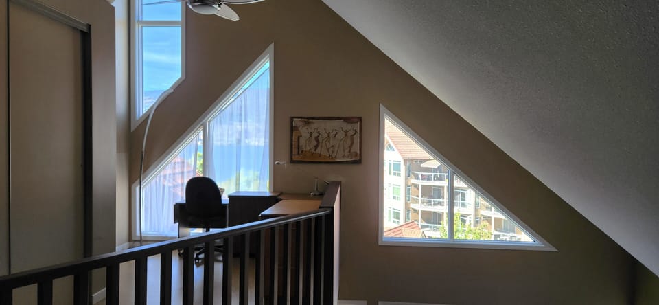 Desk in the open loft overlooking the livingroom and looking out to the lake