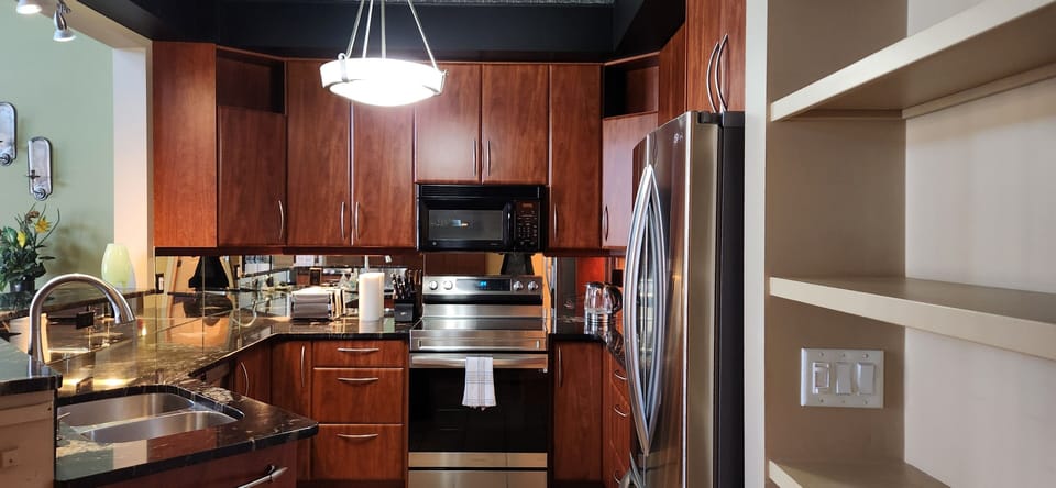 Featuring: an electric stove, dishwasher, fridge, and microwave.