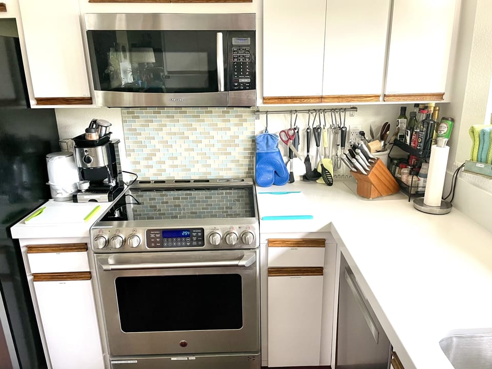 Kitchen, condiments, cooking utensils, and a beautiful view out the window.