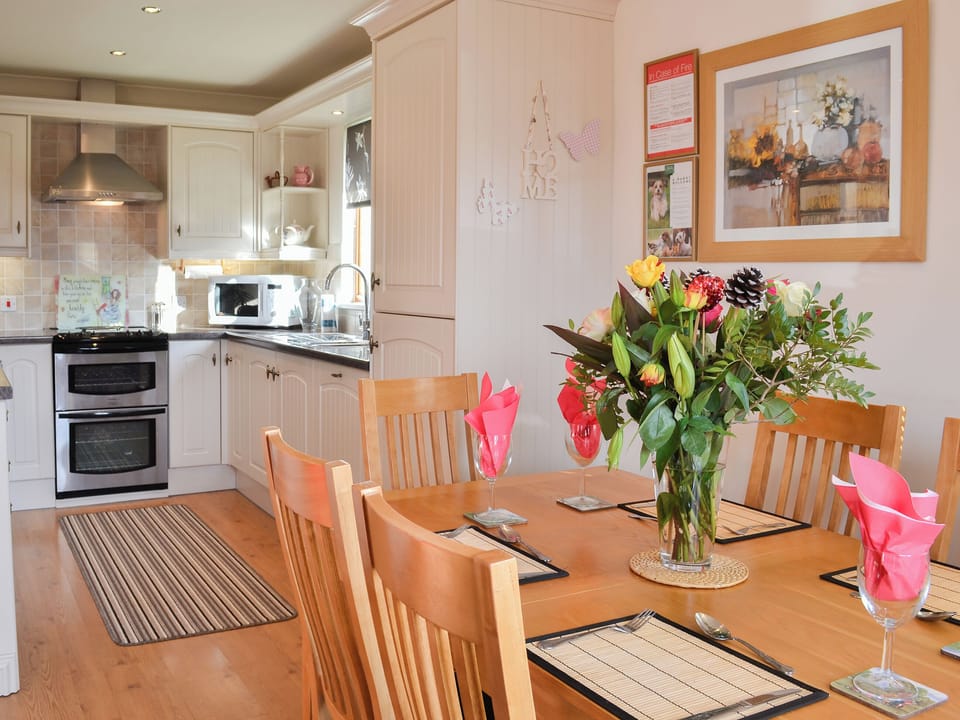 Dining table and chairs through to the kitchen | Yorkshire Rose Holiday Lodge, Sewerby, near Bridlington