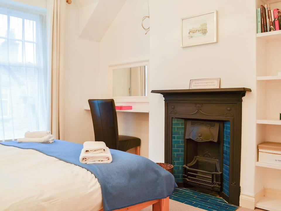Bedrom with a feature open fireplace | Lythdene, Grange-over-Sands