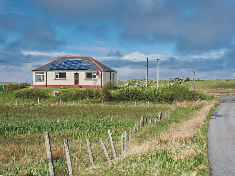Sitting on a raised area close to the Loch Roag shore | Padraig&rsquo;s Cottage, Howbeg (Tobha Beag), Isle of South Uist
