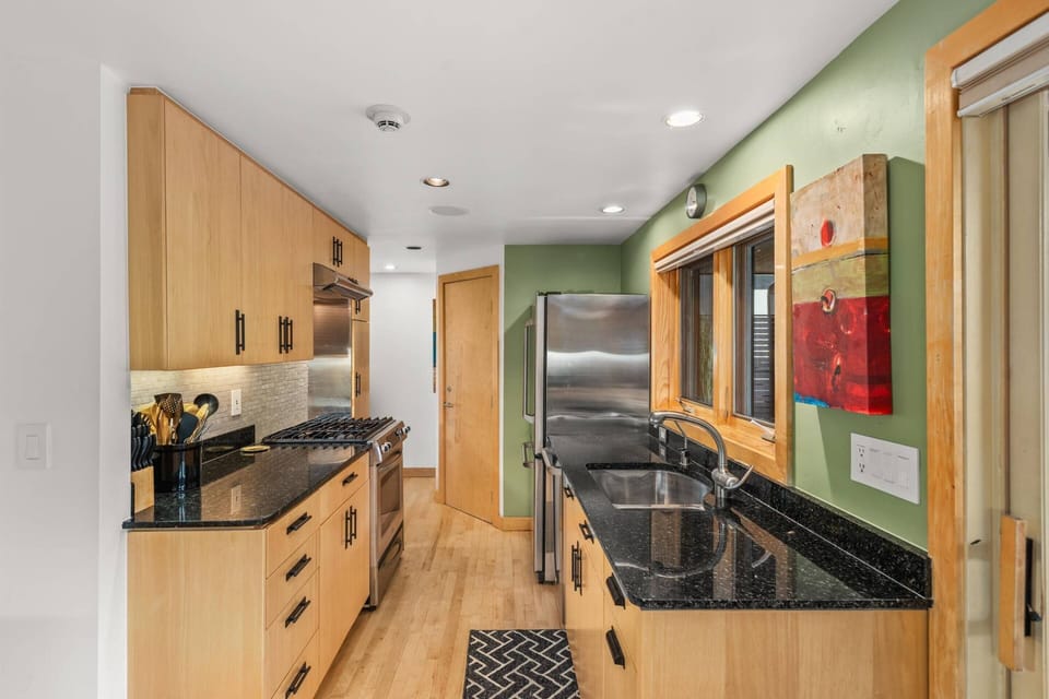 Stainless steel appliances, granite countertops, and a great view are found in the fully equipped kitchen of this condo.