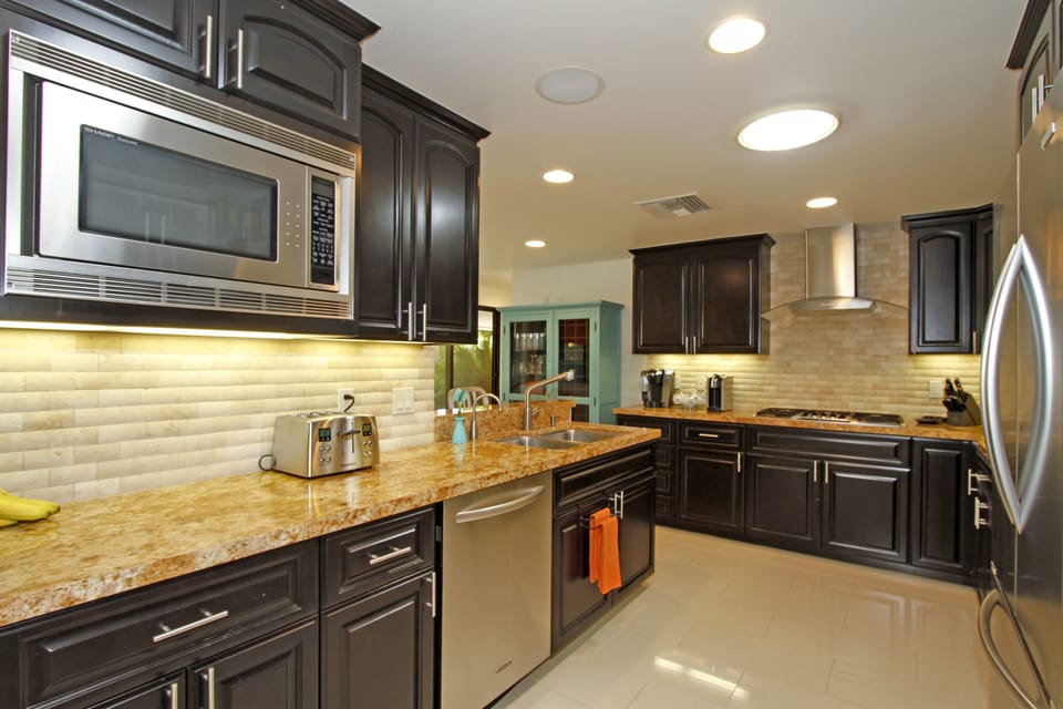 Fully equipped kitchen (2nd view) with skylights providing lots of natural light