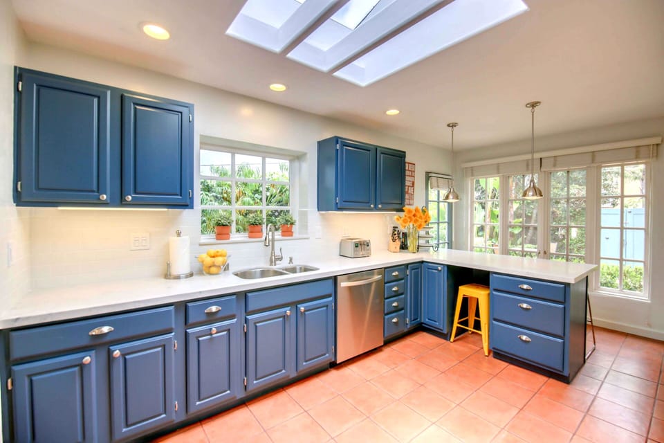 A Fully-stocked Kitchen with Expansive Work Space, Breakfast Bar, and Storage