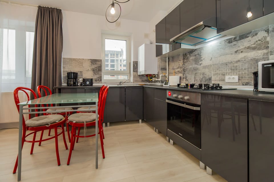 The kitchen has the oven refrigerator, coffe maker, toaster.