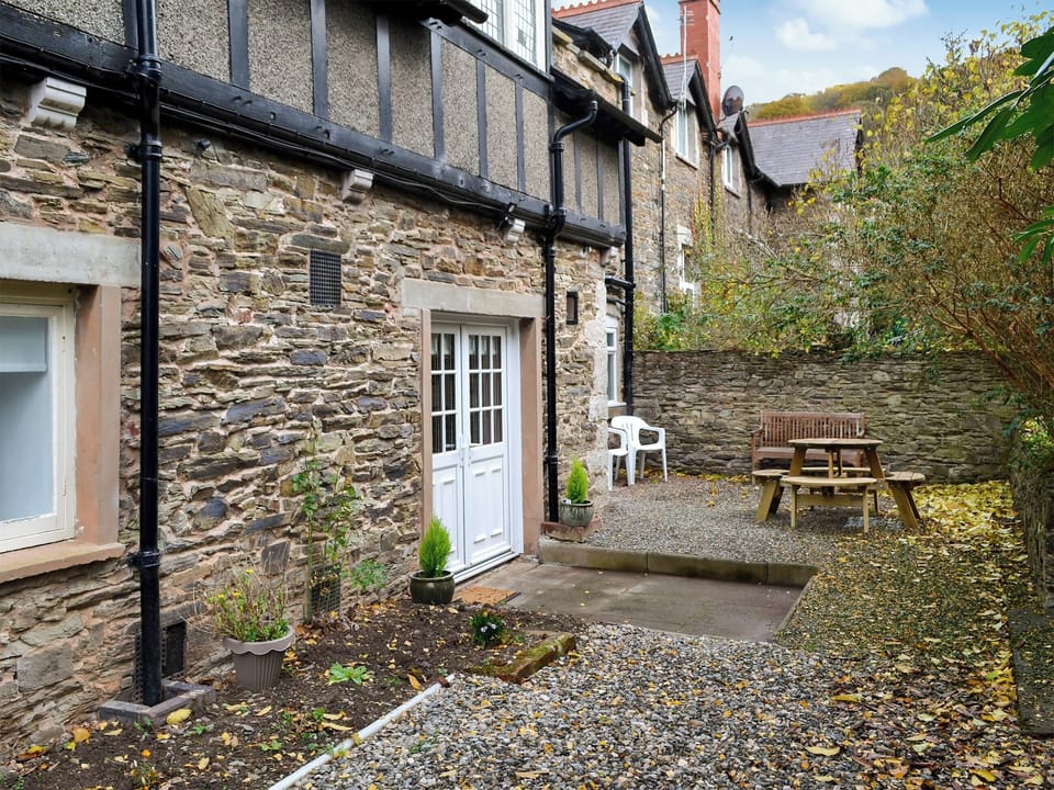  Paved and gravelled courtyard with sitting-out area and garden furniture | The East Wing at Grove Hall, Bodfari, near Denbigh
