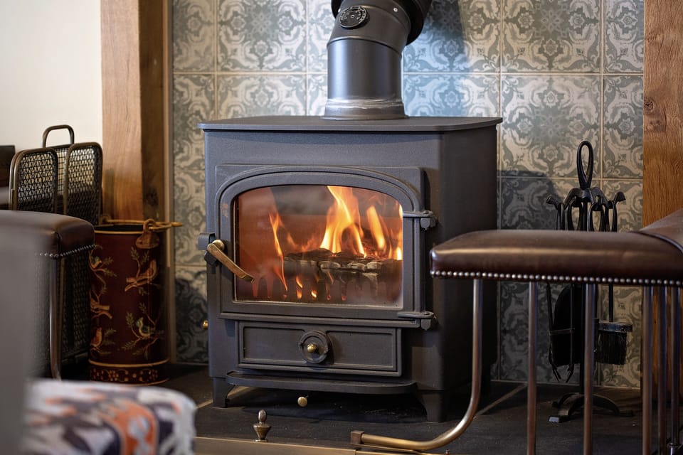 Open plan living area with woodburning stove.
