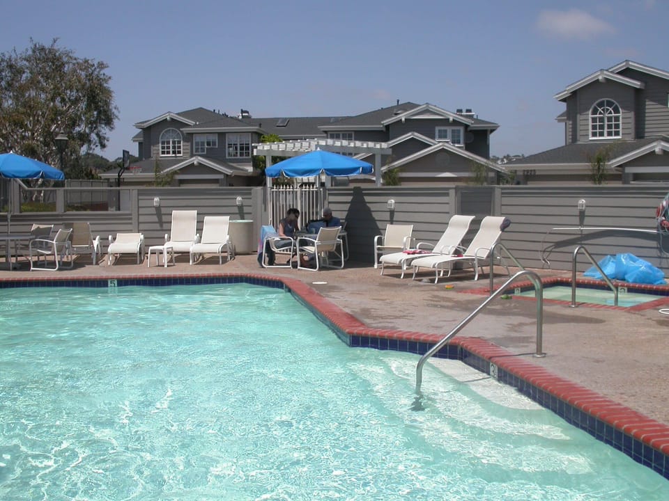 Pool with condo in background