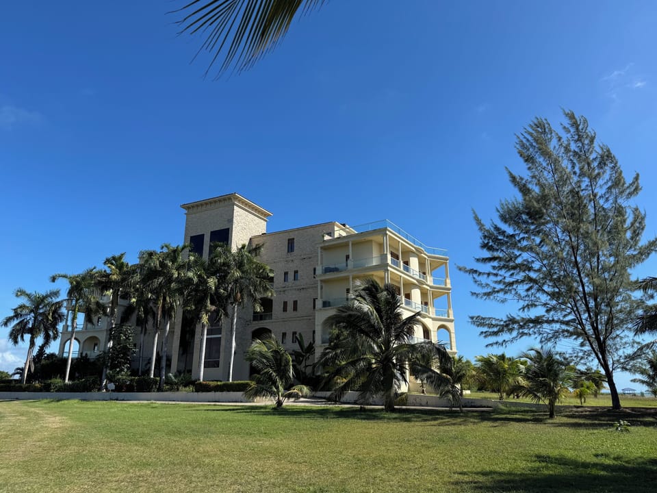 Magnificent architecture surrounded by palm trees and gardens. 