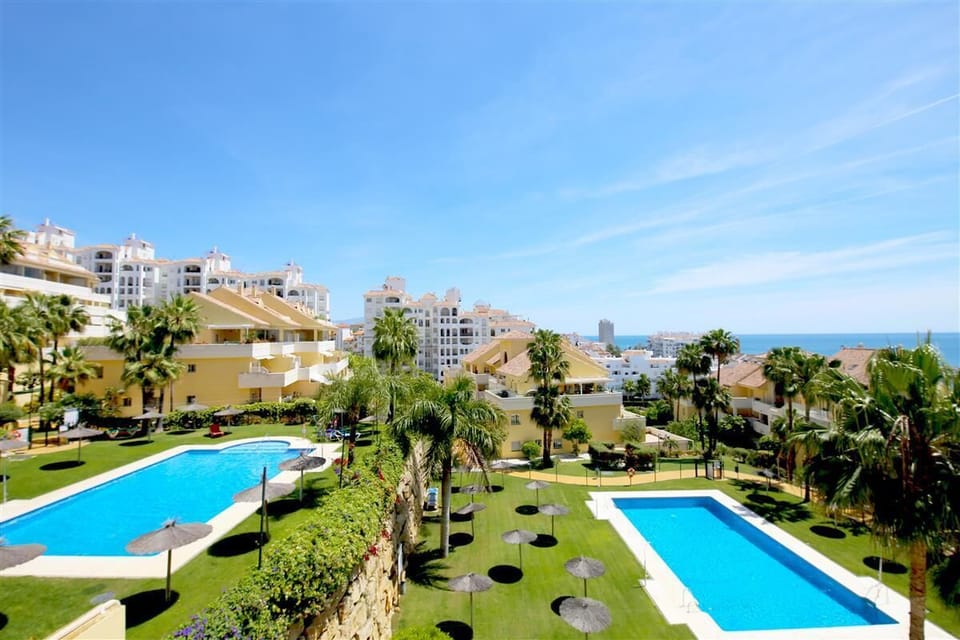 Views from the terrace to the communal pool and gardens