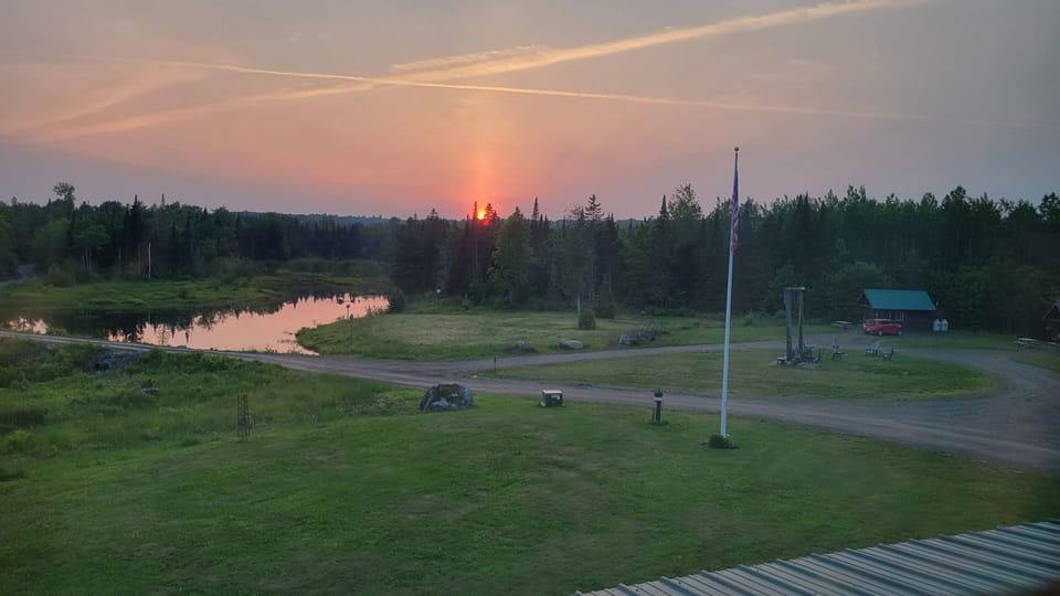 view of pond at sunset