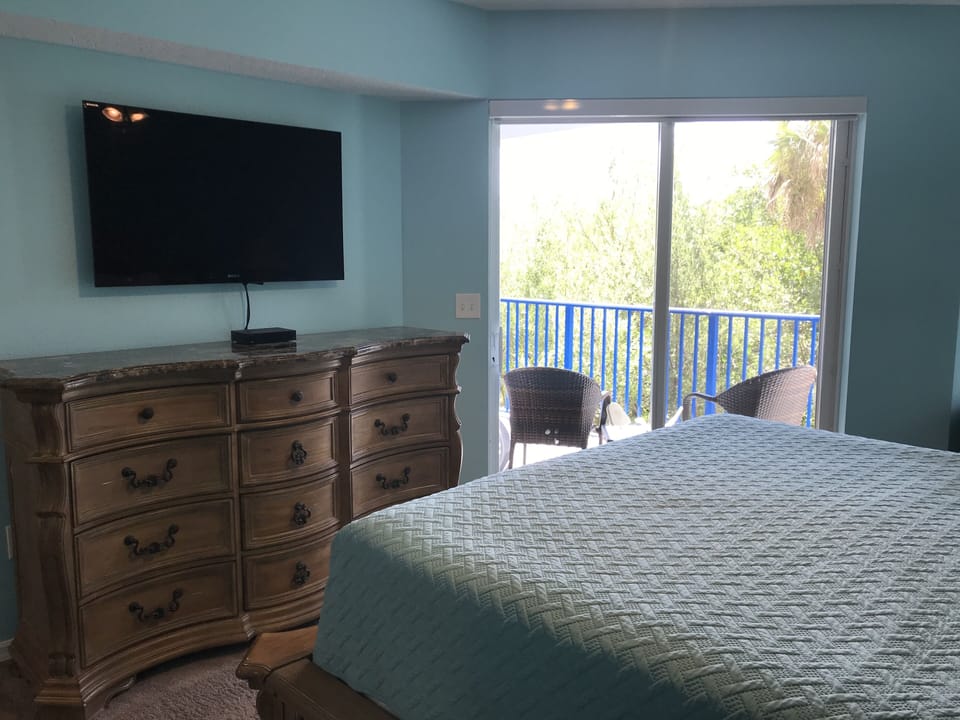 Master bedroom - flatscreen TV and sliding door to patio