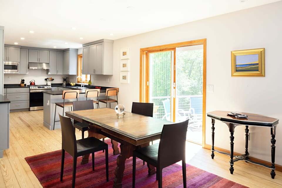 Dining area, looking out onto the porch, and our newly-renovated (2024) kitchen