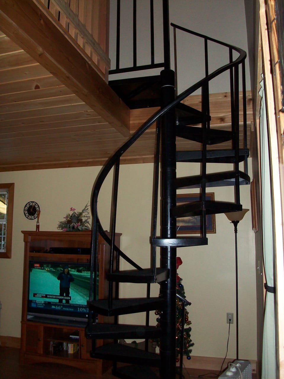 Spiral staircase leads to loft bedroom