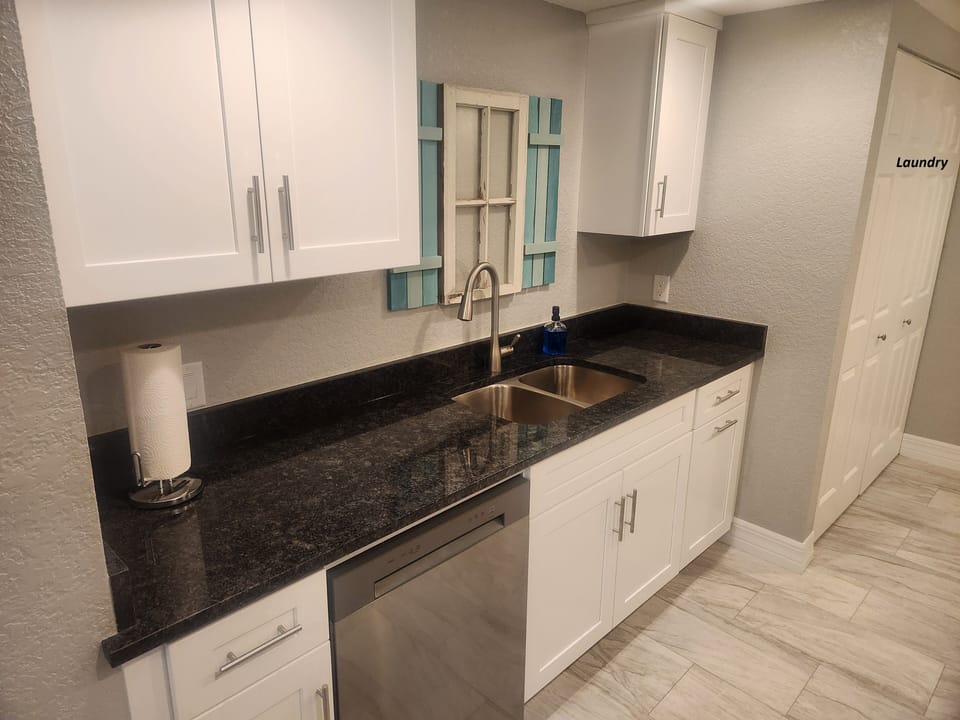 All new cabinets and granite countertops with laundry closet (upper right)