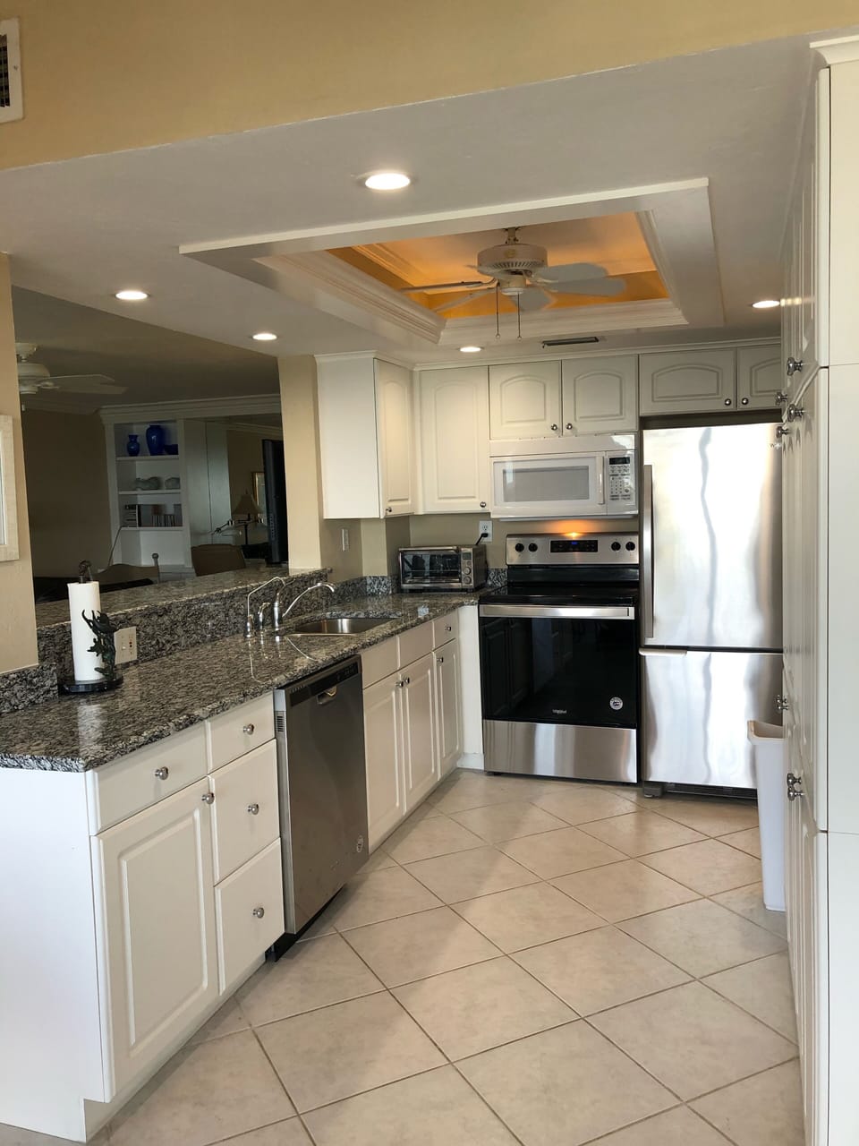 Looking through kitchen into living room and office area 