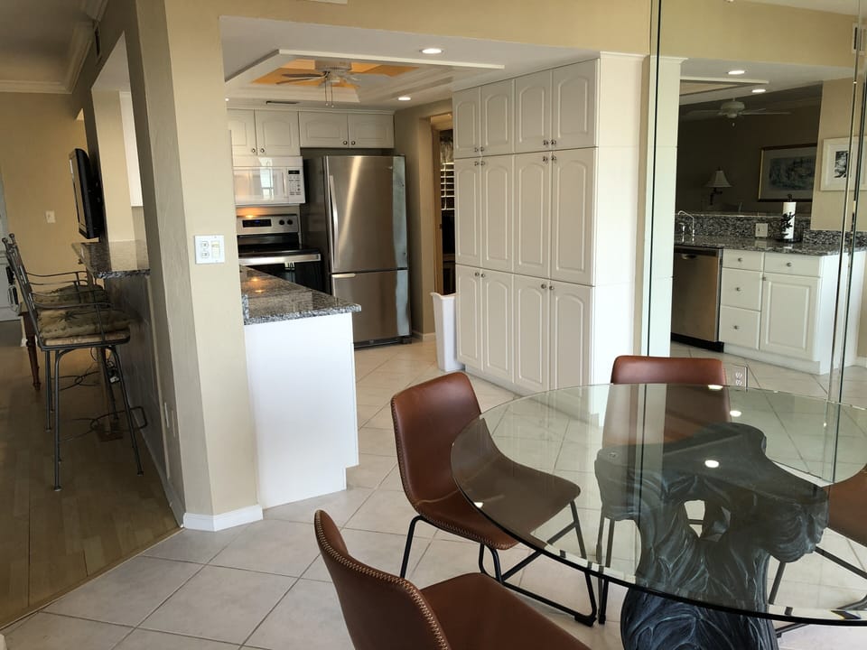 Breakfast bar on the left, looking into kitchen and dining table 