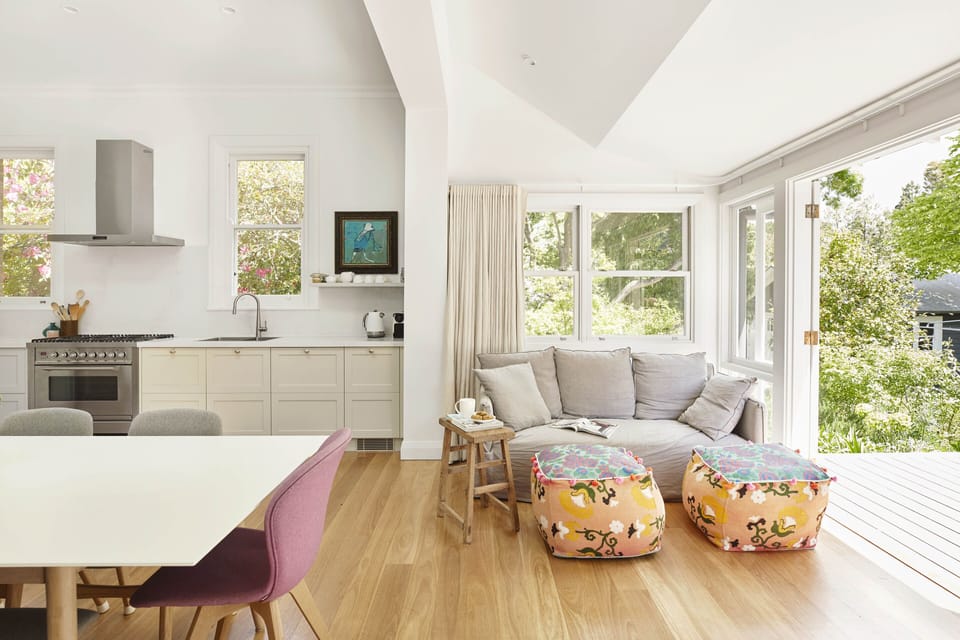 Seating area in the sunroom at the rear of the open kitchen dining area