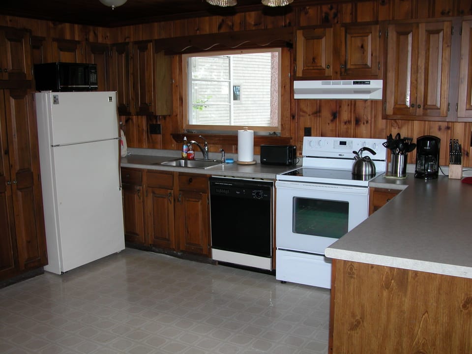 Kitchen which is part of large living area with views of Highland Lake