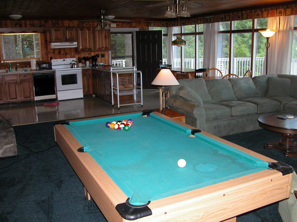 view from living area toward kitchen, eating area with deck in background