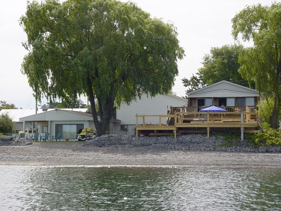 This is an old photo of the property. There is now a deck along the entire beach