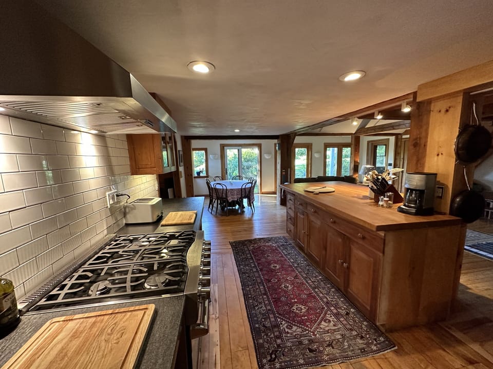 Modern kitchen with Viking stove and extensive collection of pots and pans.