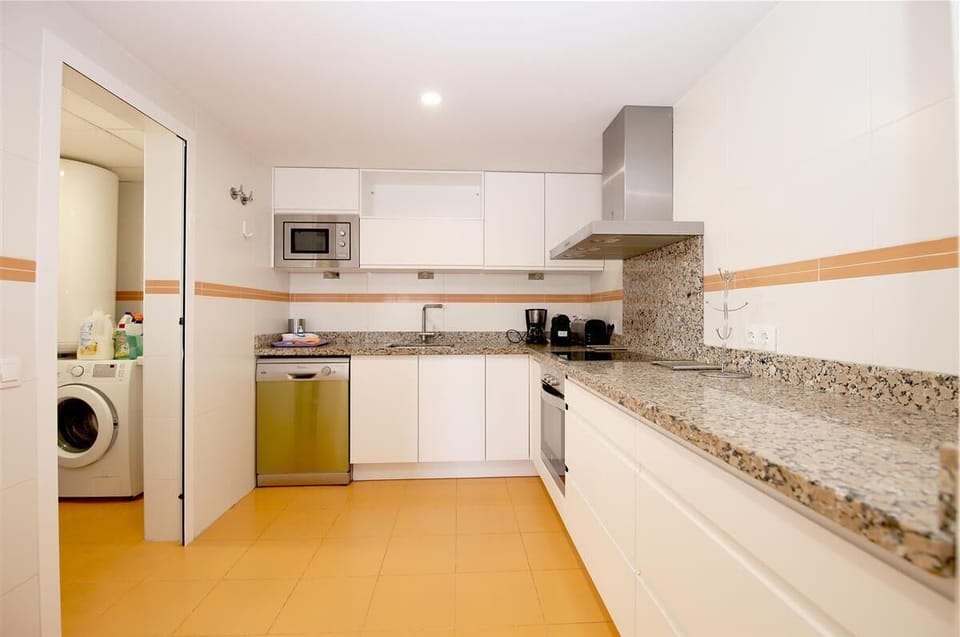 Another picture of the kitchen with laundry room to the side