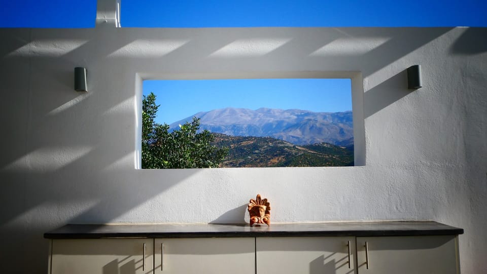 Window in bar wall offers 16K view on Mount Psiloritis (2.453m)