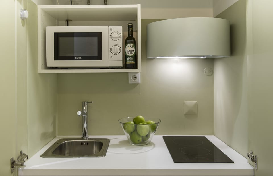 The kitchenette is small, but equipped with stove, microwave, coffee machine
