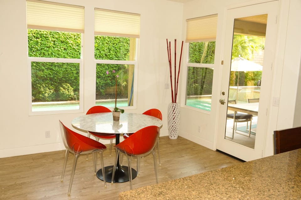 Kitchen view of Breakfast Room, with entry to Outside Living Area and Pool.