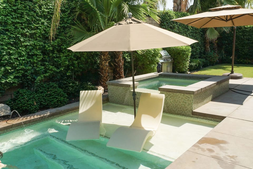 Sit back and enjoy the  unique sunbathing shelf in the pool. 