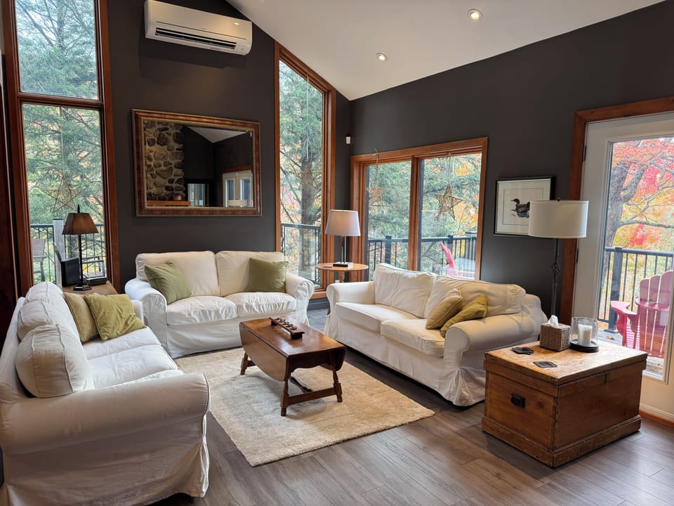 Sun-filled living room with panoramic views of the mountain.