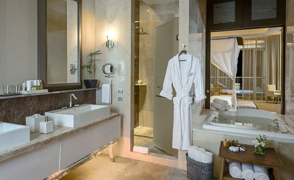 Master bath with double vanity, jetted tub, and separate shower