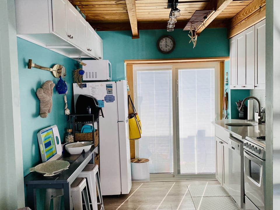 Kitchen with microwave, air fryer, stove, fridge, dishwasher, Keurig 