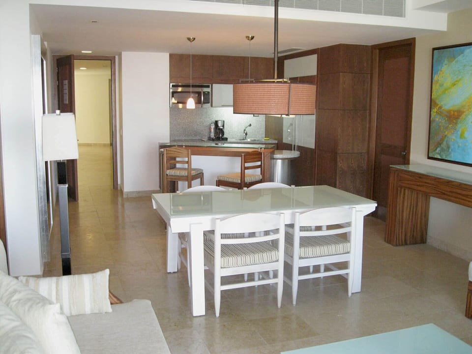 Grand Bliss kitchen area with island behind dining table