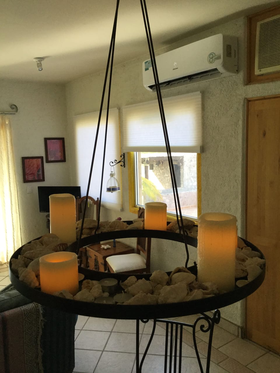 Sea shell candle opera over dining table .