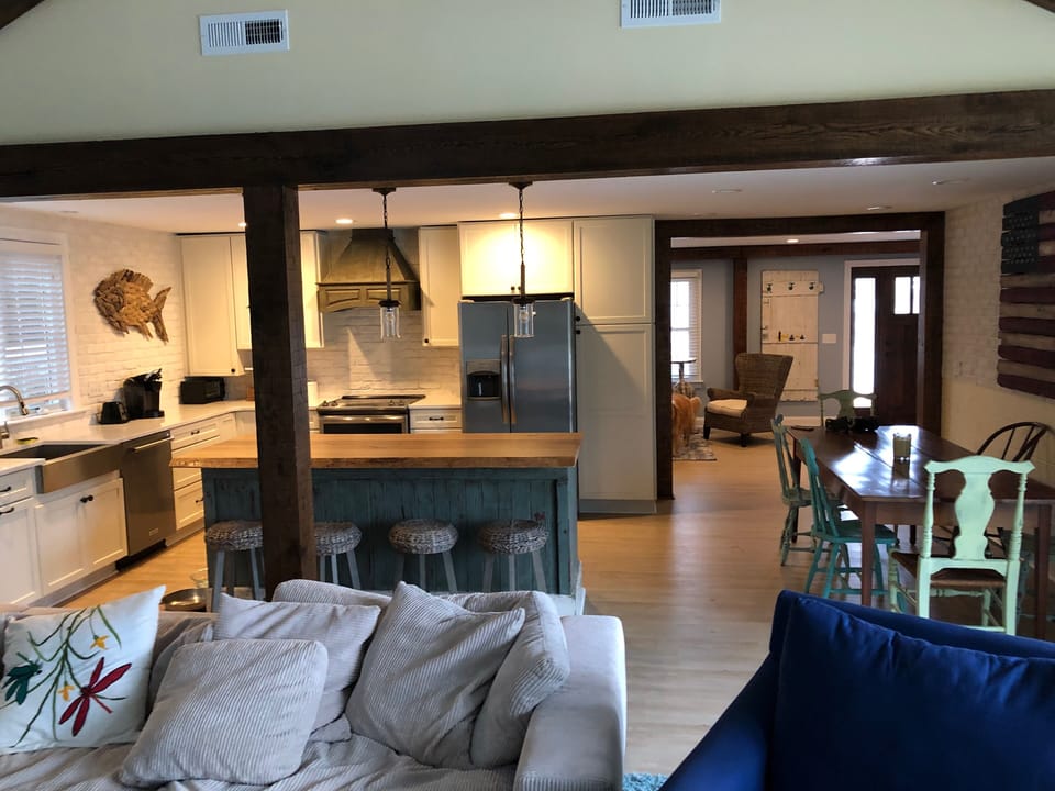Open kitchen next to vaulted ceiling room
