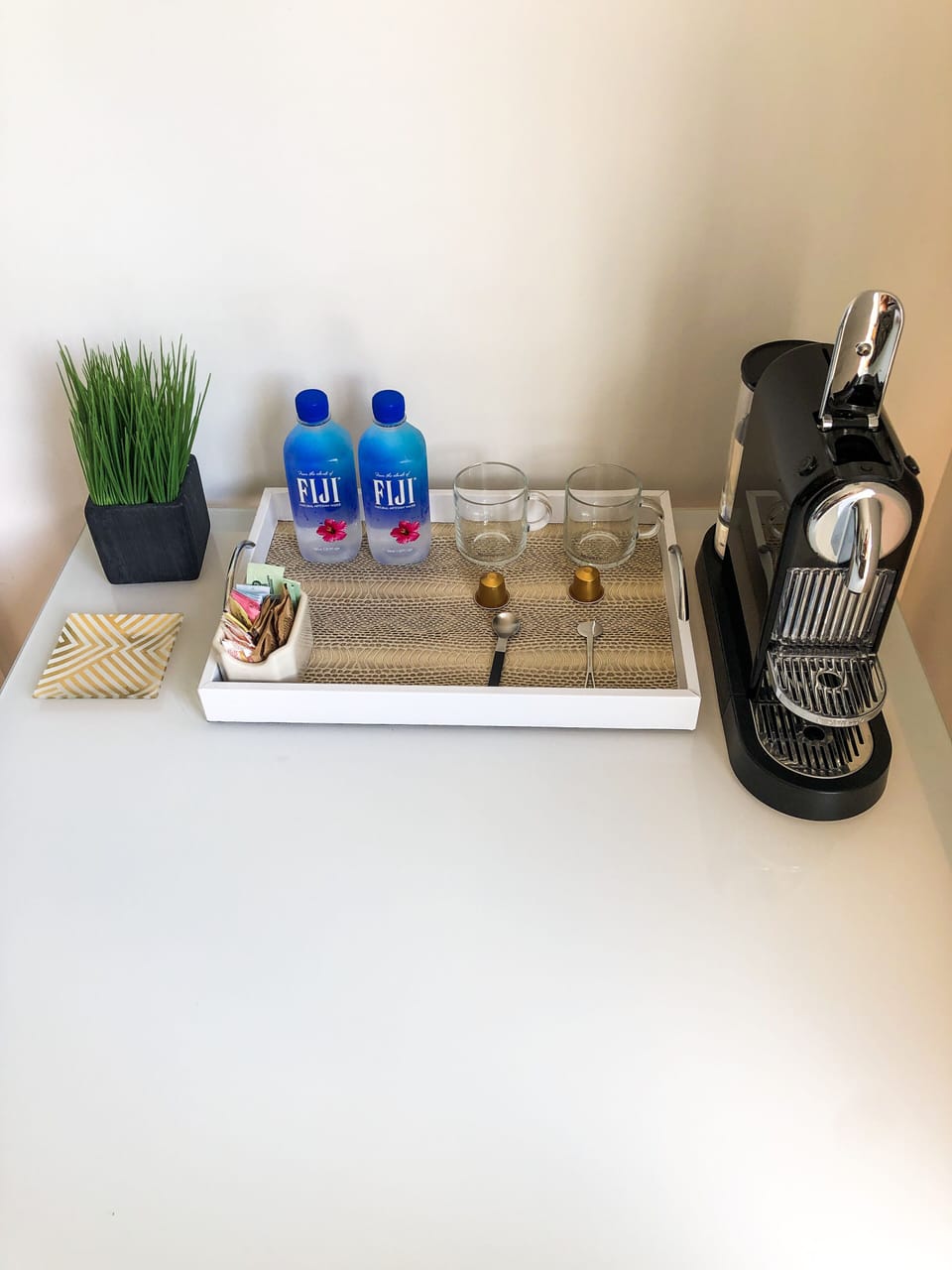 Nespresso coffee and water in bedroom

