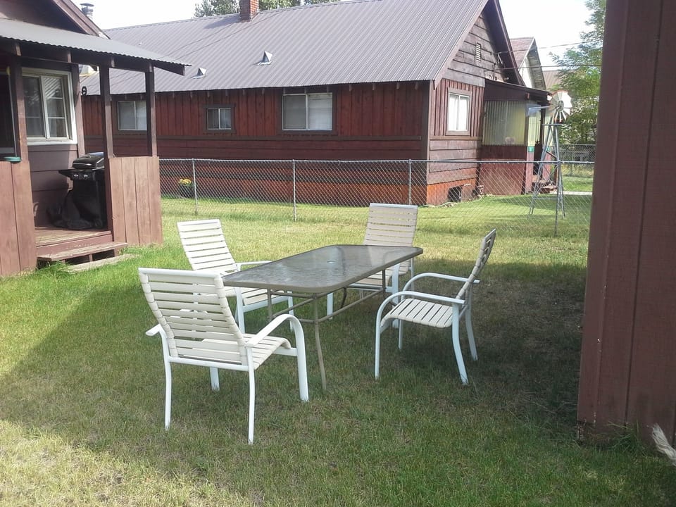 back yard with  BBQ on back porch and table"+