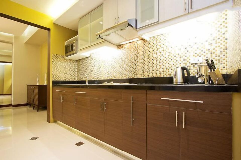 fully functional kitchen, with stove, microwave, kitchen utensils, pots and pans