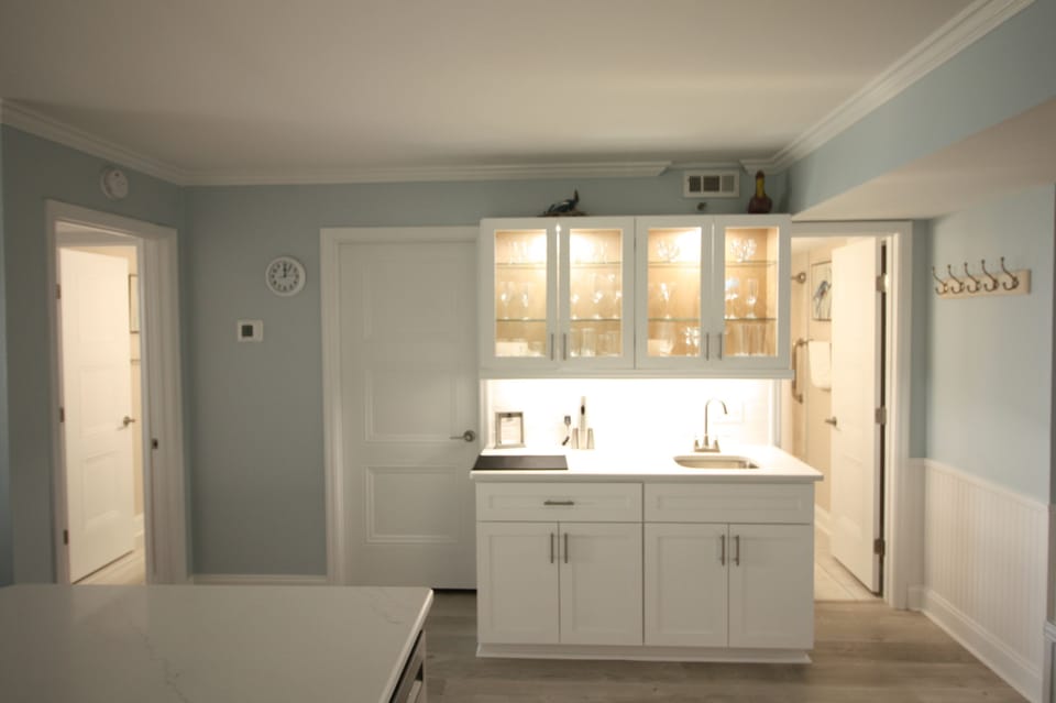 New wet bar with nice selection of glasses for your favorite cocktails.