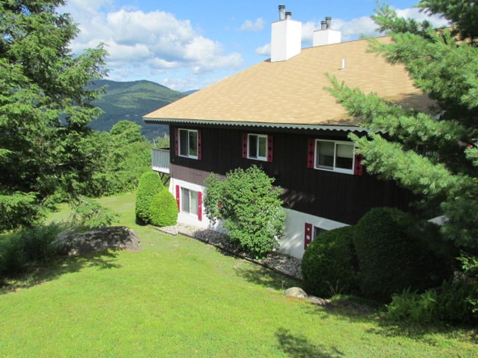 Side of chalet building, looking west  from driveway