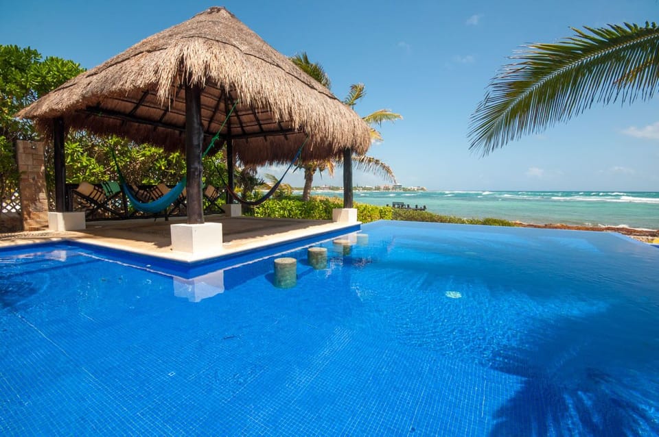 Palapa by the pool with hammocks for you to relax with your favorite cocktail
