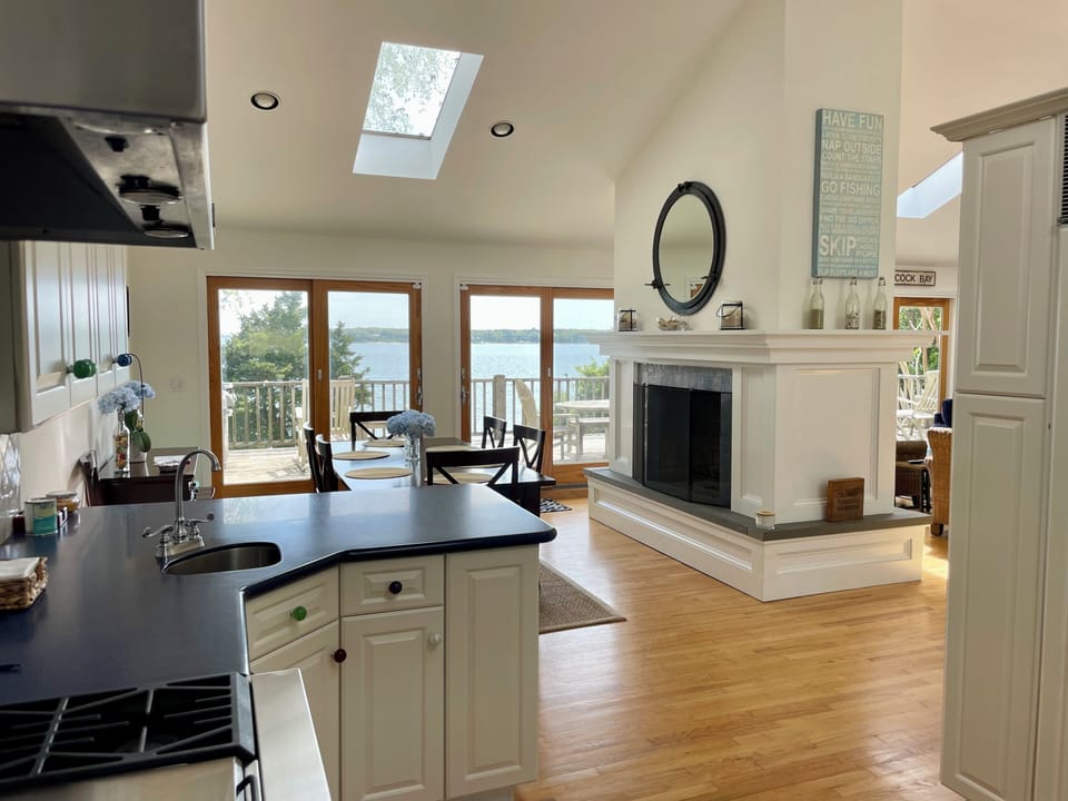 View from kitchen looking out to dining, living and outdoor deck.