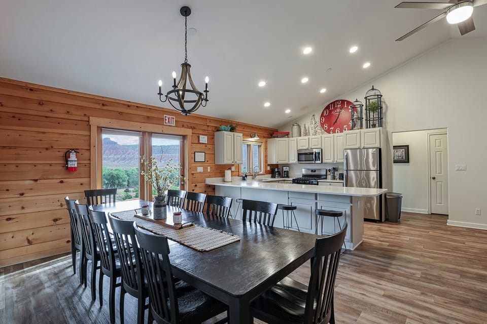 Our Chalet kitchen features stainless steel appliances, including a gas stovetop, alongside a spacious kitchen and dining living room area.