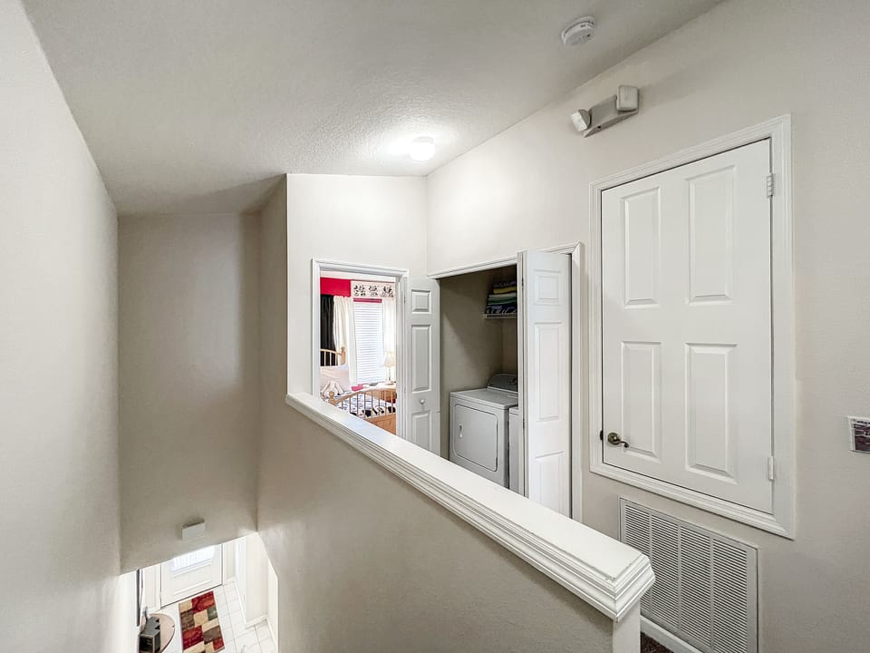 Bright upstairs hallway with easy access to all bedrooms and laundry area.